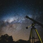 Stunning starry sky with silhouette of telescope capturing the Milky Way in Brazil.